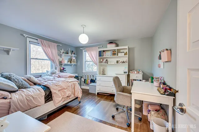 a room with wooden floor and gym equipment