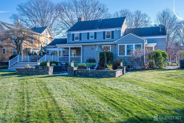 a front view of residential houses with yard and green space