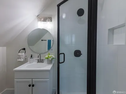a bathroom with a sink mirror and vanity