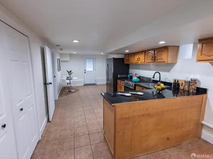 a kitchen with stainless steel appliances granite countertop a refrigerator and a stove top oven