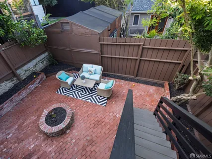 a view of a roof deck with wooden floor and a floor to ceiling window