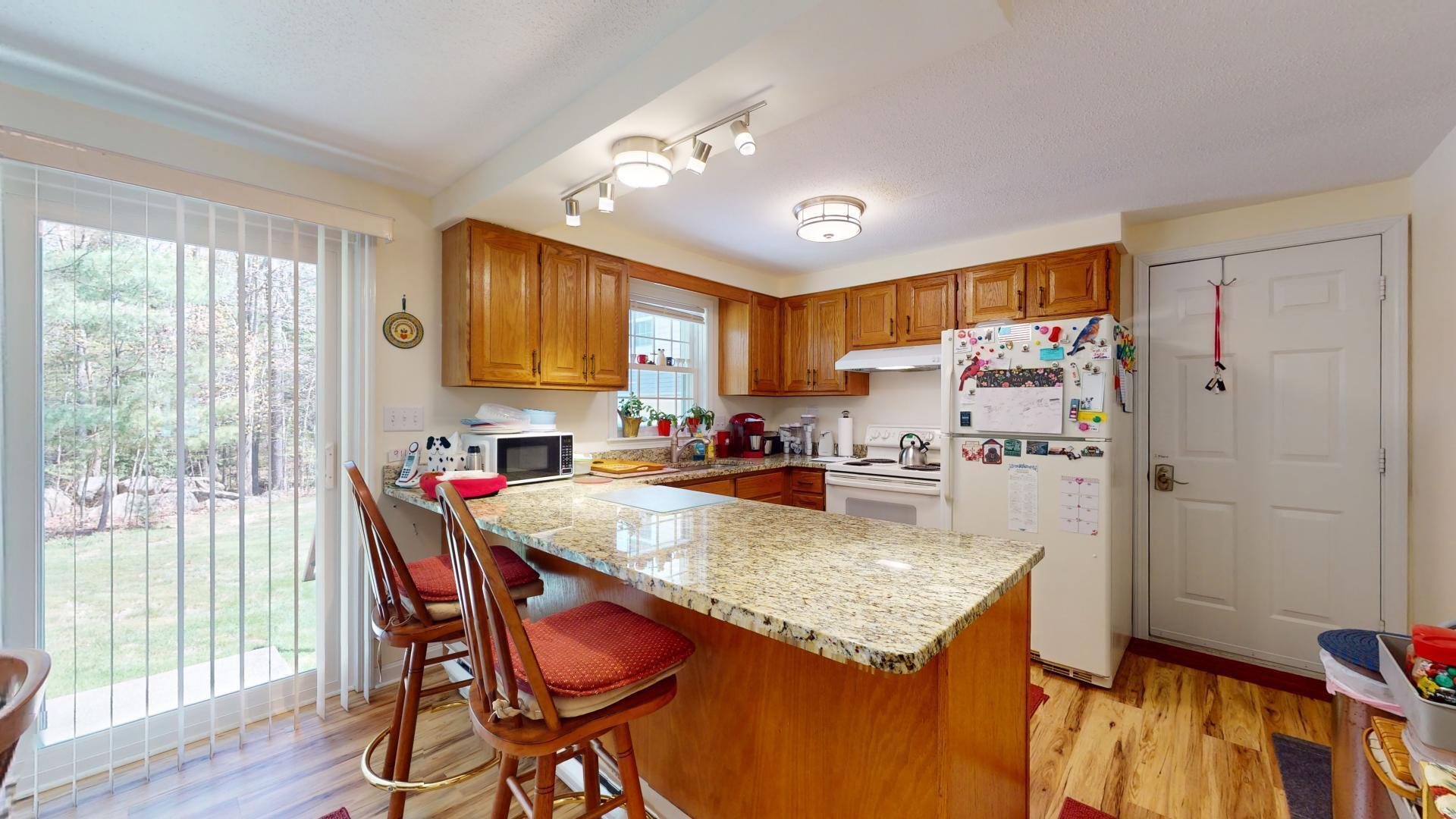 149 Flintlock Village, Unit 3 Wells, ME 04090 - Photo 7 of 24 Kitchen with eat up counter