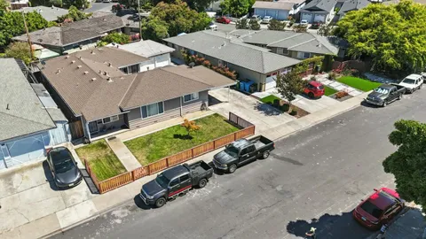 an aerial view of a house with garden space and street view