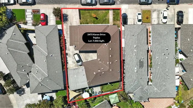 an aerial view of residential houses with outdoor space and street view