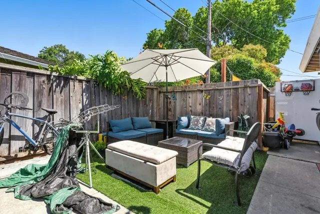 a view of a backyard with a patio and outdoor seating