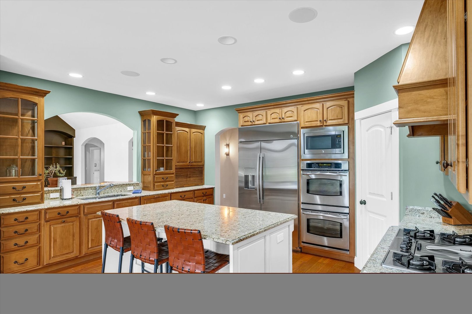 1803 Cobblefield Court Champaign, IL 61822 - Photo 12 of 55 a kitchen with stainless steel appliances kitchen island granite countertop a refrigerator and a stove top oven