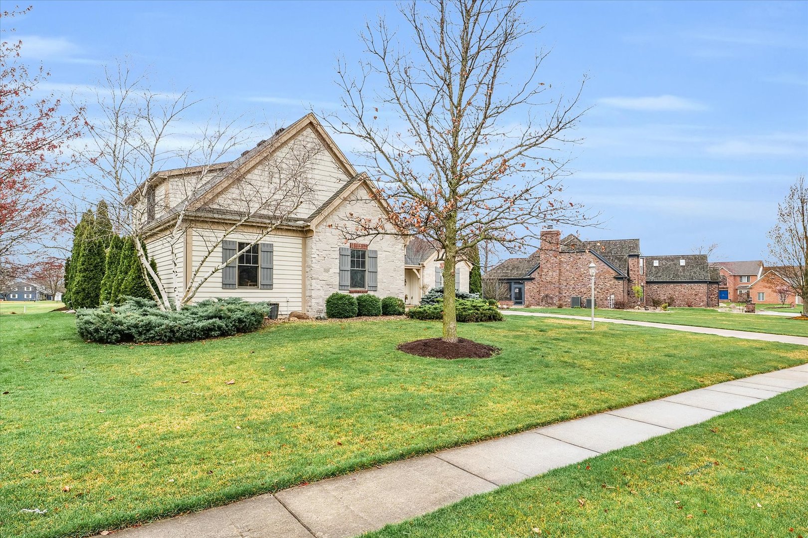 1803 Cobblefield Court Champaign, IL 61822 - Photo 4 of 55 a view of a house with a big yard potted plants and large tree