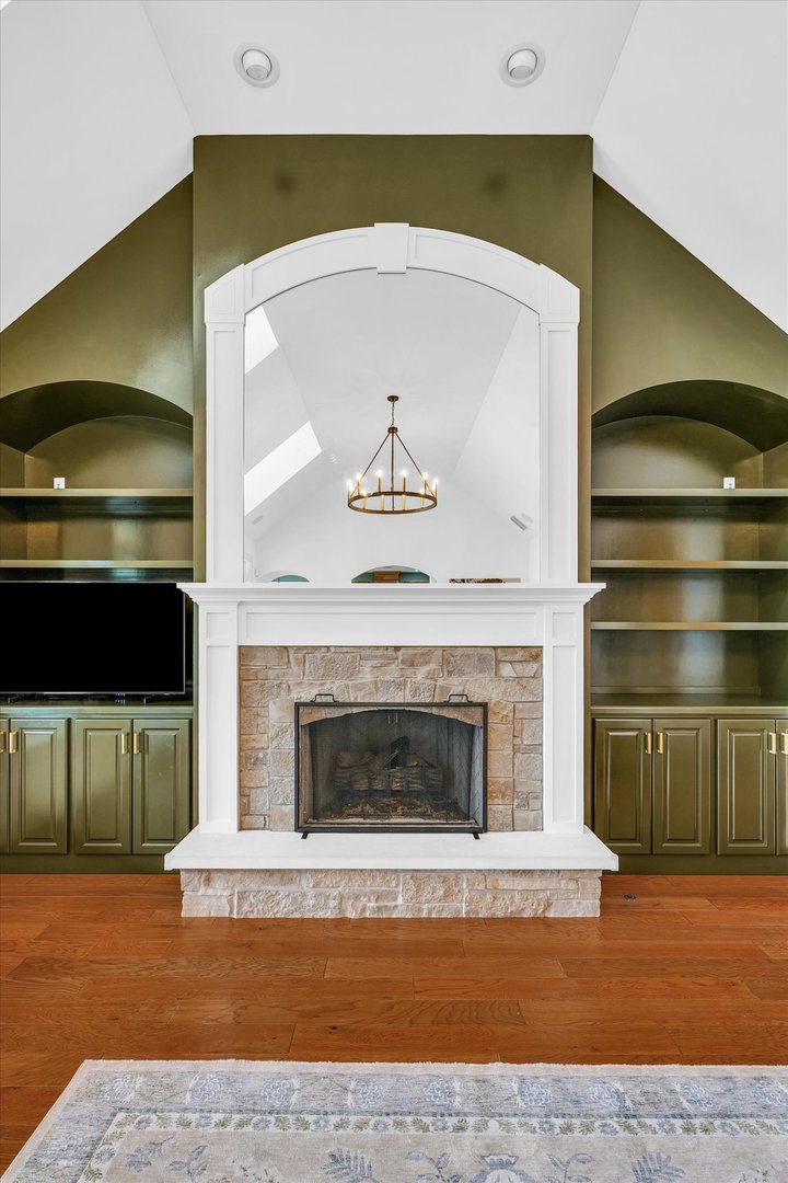 1803 Cobblefield Court Champaign, IL 61822 - Photo 8 of 55 a living room with a fireplace and a flat screen tv