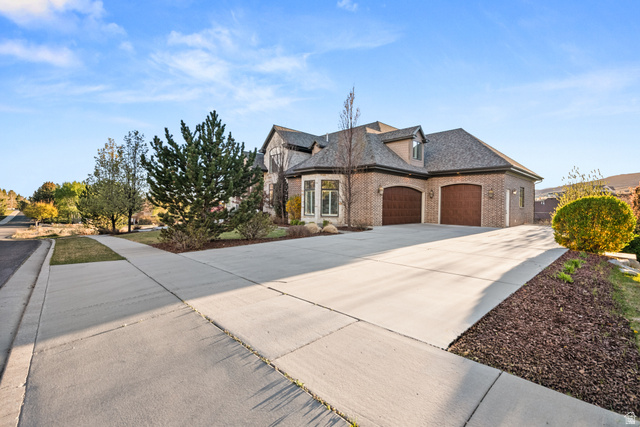 1205 North Elk Rdg Lane, Unit 202 Alpine, UT 84004 - Photo 5 of 88 Brick exterior with a multi-gabled roofline and two arched garage doors