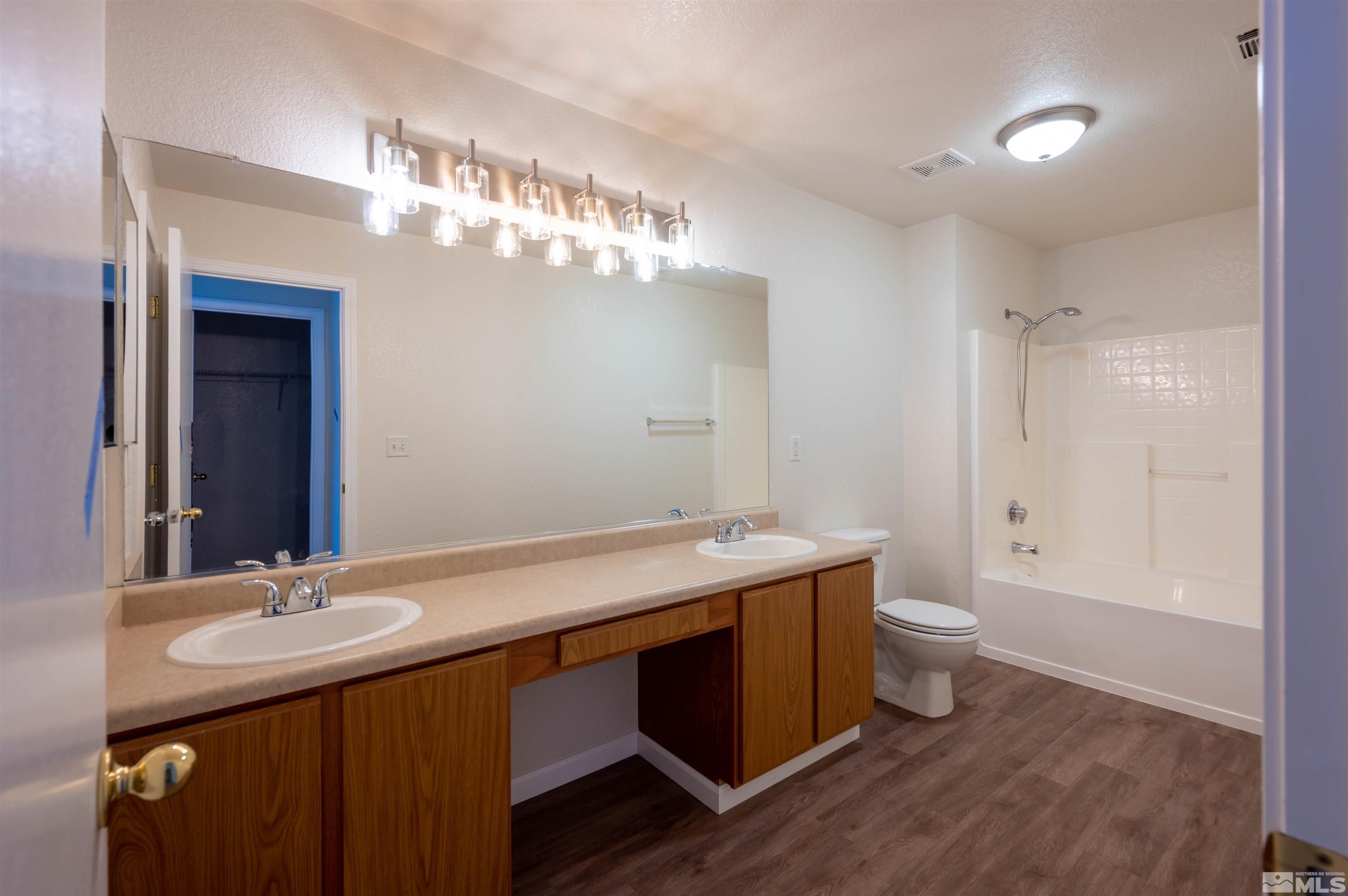 9615 Autumn Leaf Way Reno, NV 89506 - Photo 18 of 24 a bathroom with a double vanity sink mirror and toilet