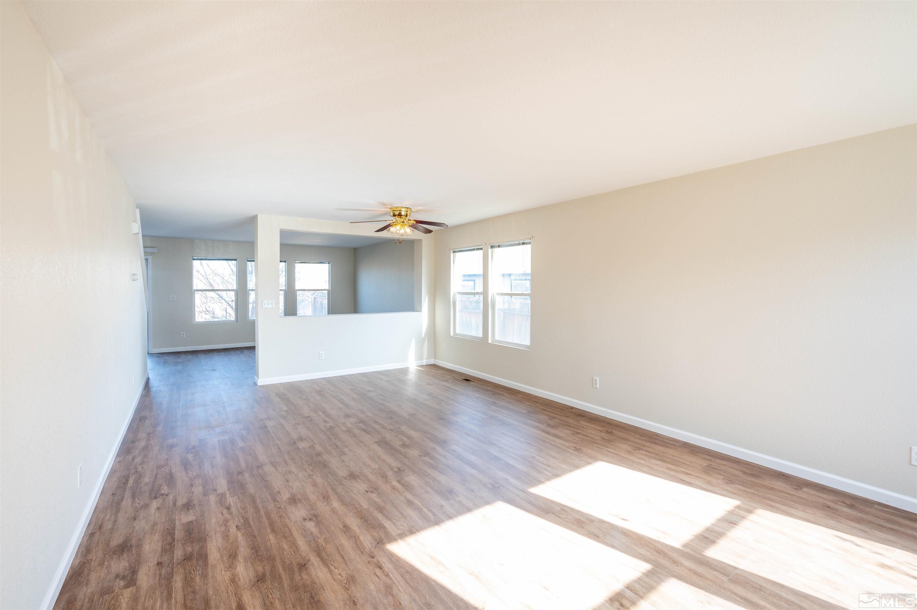 9615 Autumn Leaf Way Reno, NV 89506 - Photo 5 of 24 an empty room with wooden floor and windows