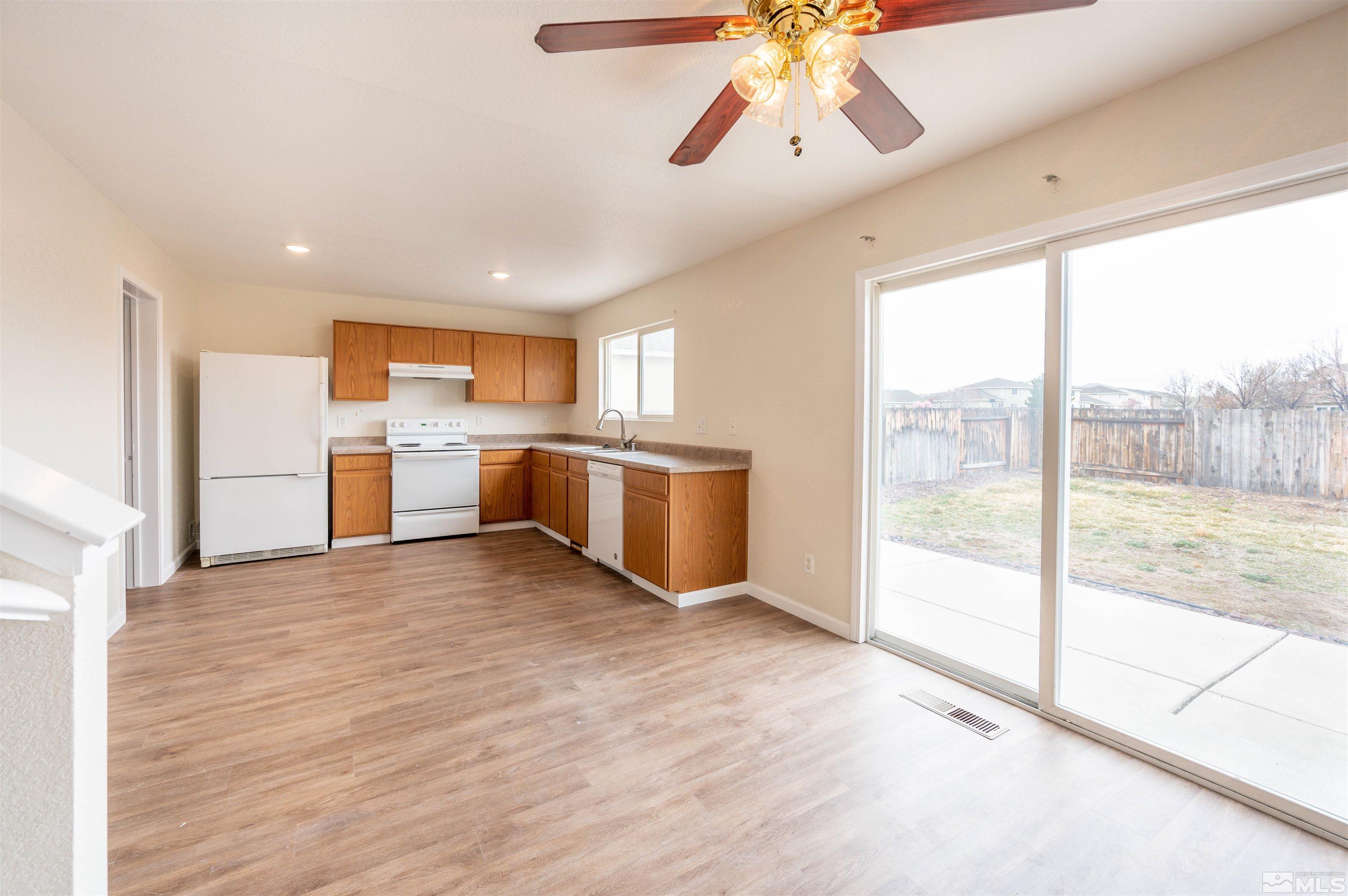 9615 Autumn Leaf Way Reno, NV 89506 - Photo 7 of 24 a view of a kitchen with a stove cabinets and wooden floor