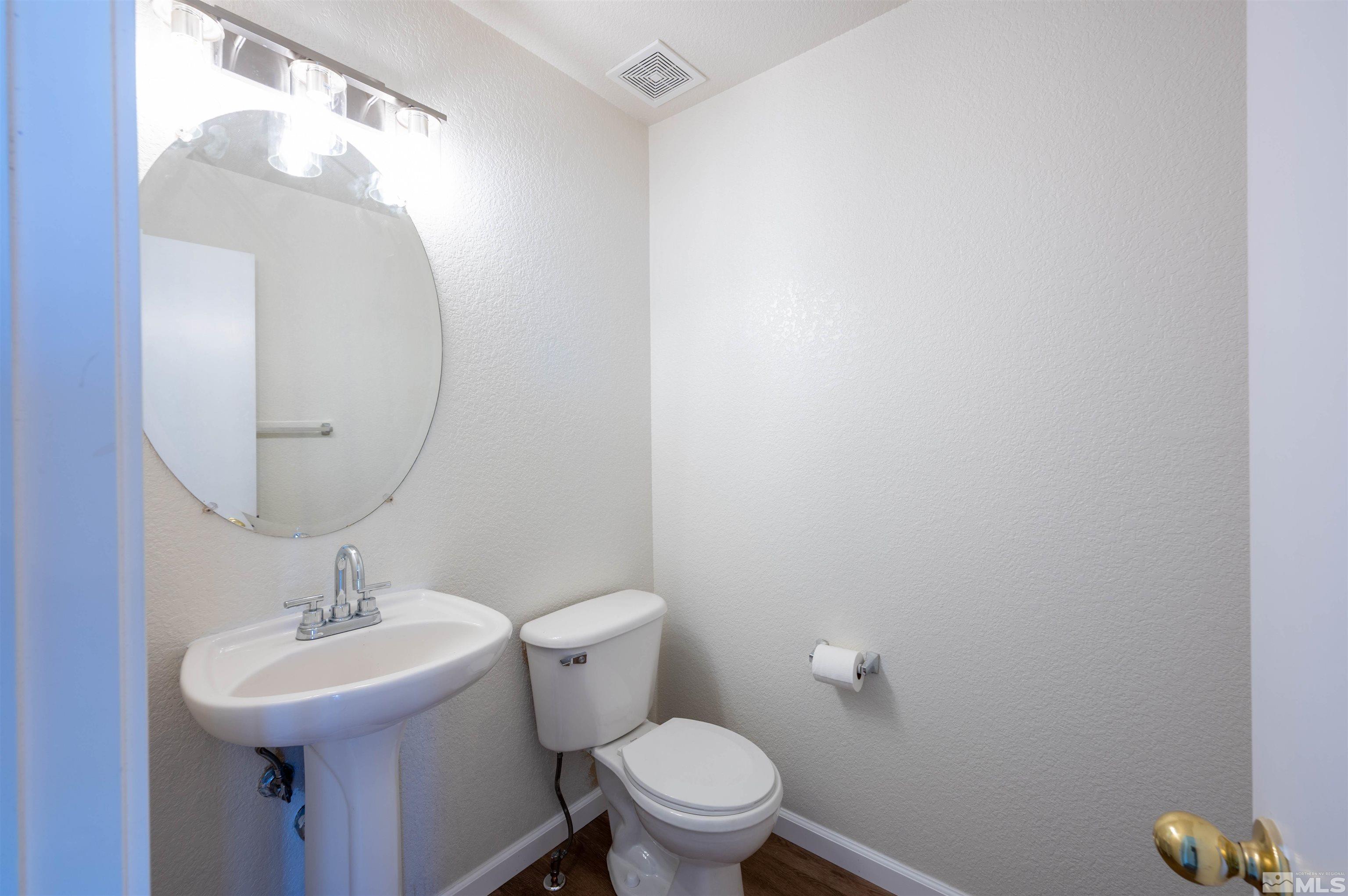 9615 Autumn Leaf Way Reno, NV 89506 - Photo 10 of 24 a bathroom with a sink mirror and toilet