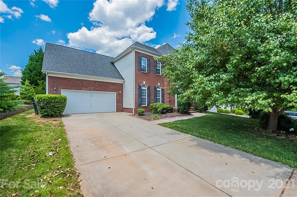 3546 Weddington Ridge Lane Matthews, NC 28105 - Photo 1 of 24 a front view of a house with garden