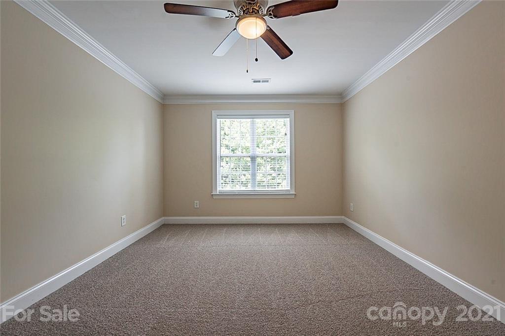3546 Weddington Ridge Lane Matthews, NC 28105 - Photo 18 of 24 an empty room with ceiling fan and windows