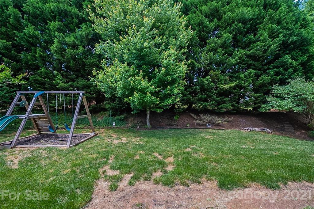 3546 Weddington Ridge Lane Matthews, NC 28105 - Photo 20 of 24 a view of a backyard with a wooden deck