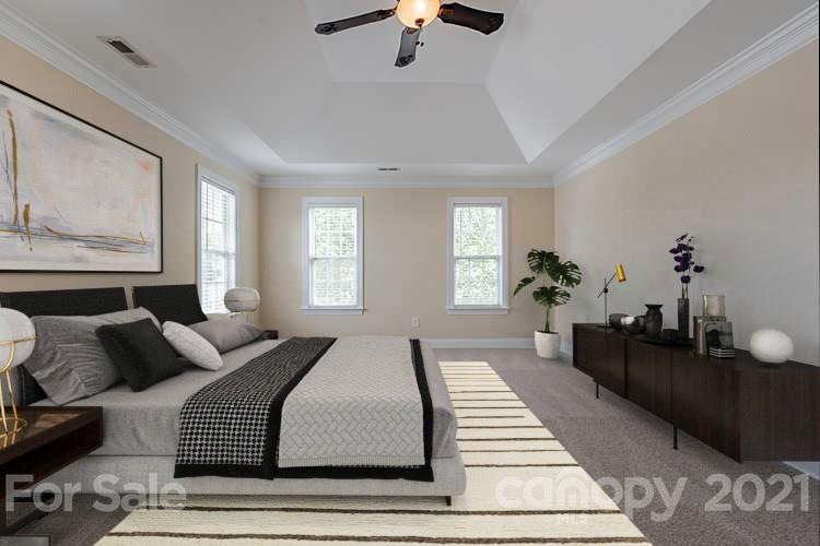 3546 Weddington Ridge Lane Matthews, NC 28105 - Photo 3 of 24 a bedroom with a large bed and a chandelier