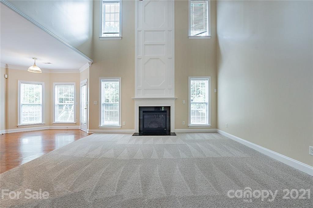 3546 Weddington Ridge Lane Matthews, NC 28105 - Photo 5 of 24 a view of an empty room with a fireplace and a window
