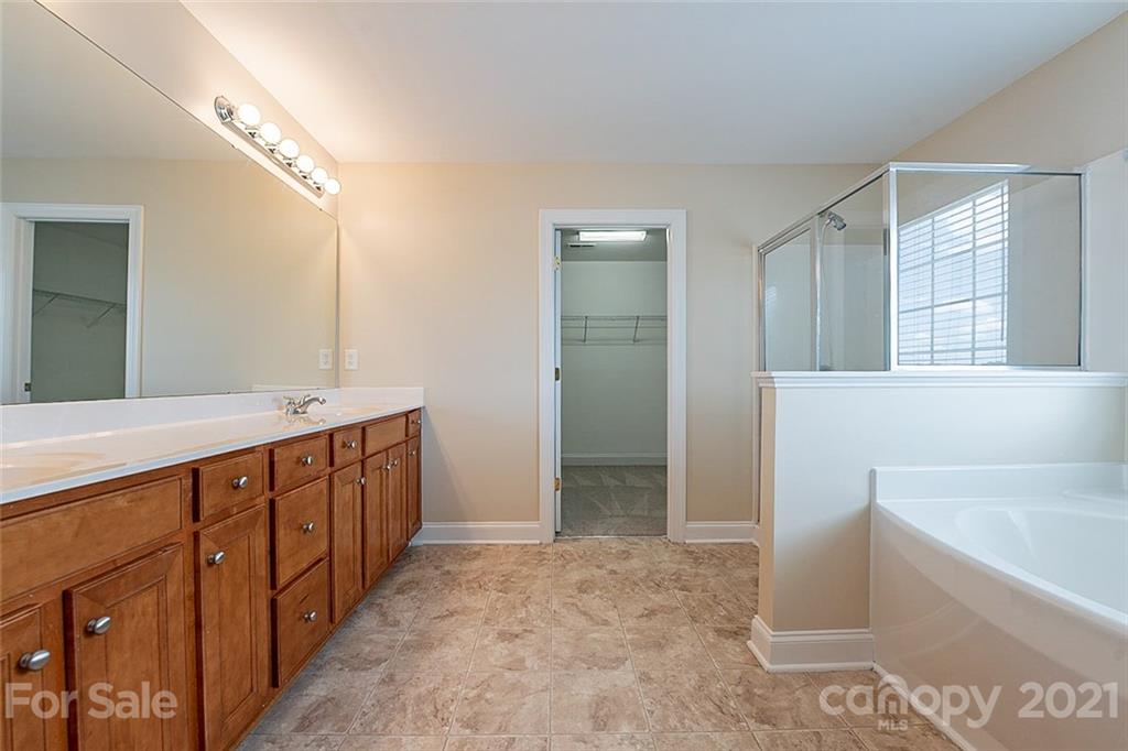 3546 Weddington Ridge Lane Matthews, NC 28105 - Photo 6 of 24 a bathroom with a tub a double vanity sink and mirror