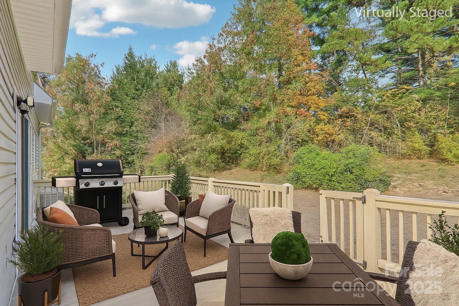 136 Ridge Brook Drive Weaverville, NC 28787 - Photo 4 of 41 a view of a balcony with chairs and a potted plant