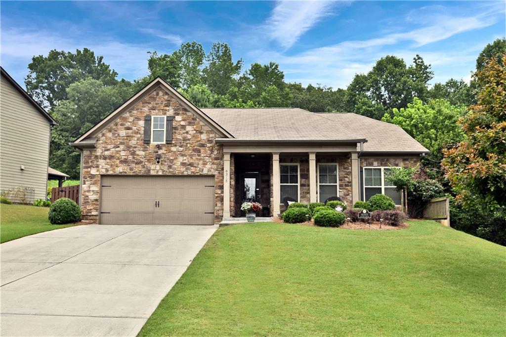 6315 Country Lake Road Cumming, GA 30041 - Photo 1 of 1 a front view of a house with garden