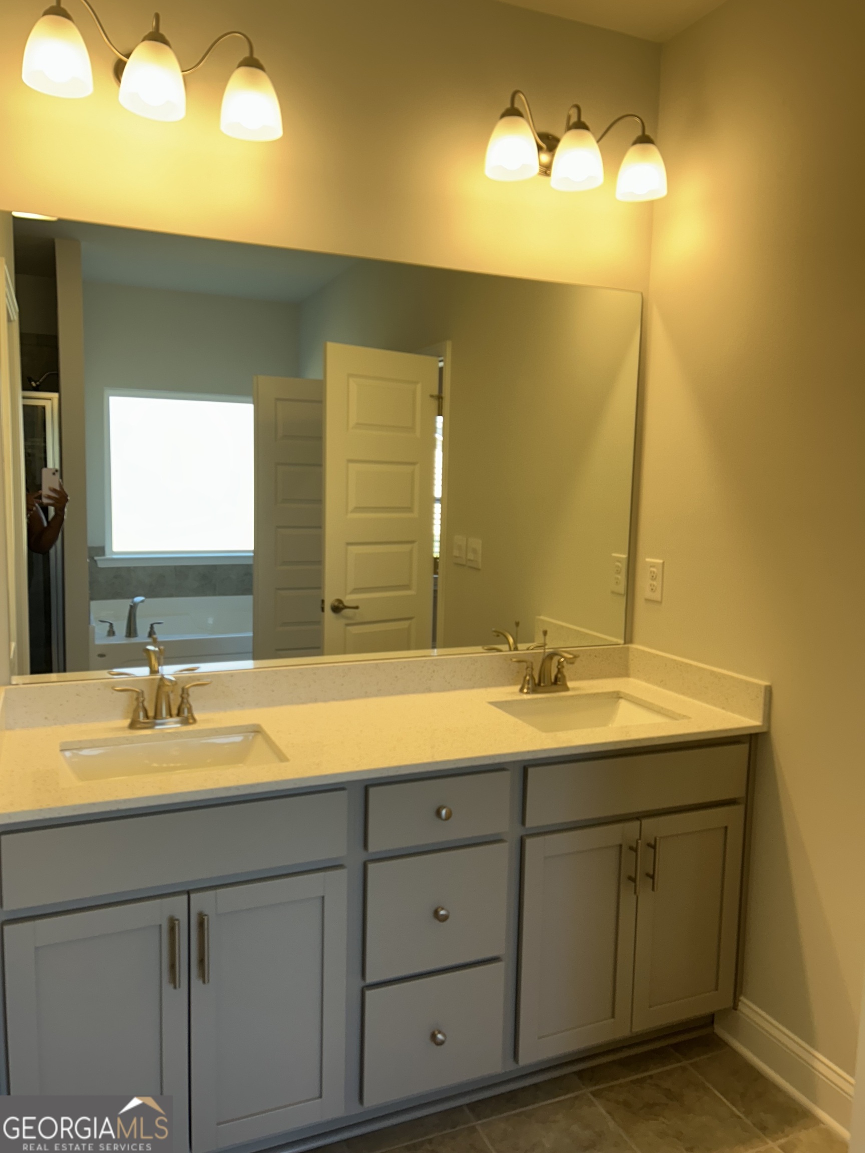 1402 Barrington Pl Way Macon, GA 31220 - Photo 3 of 12 a bathroom with a double vanity sink and a mirror