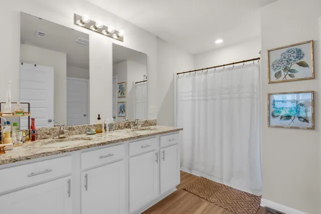 a bathroom with a double vanity sink and a mirror