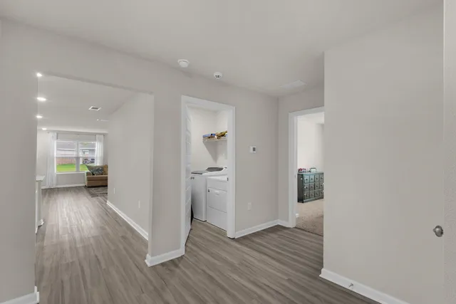 a view of a hallway with wooden floor