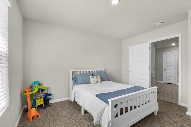 a bedroom with a bed and a window