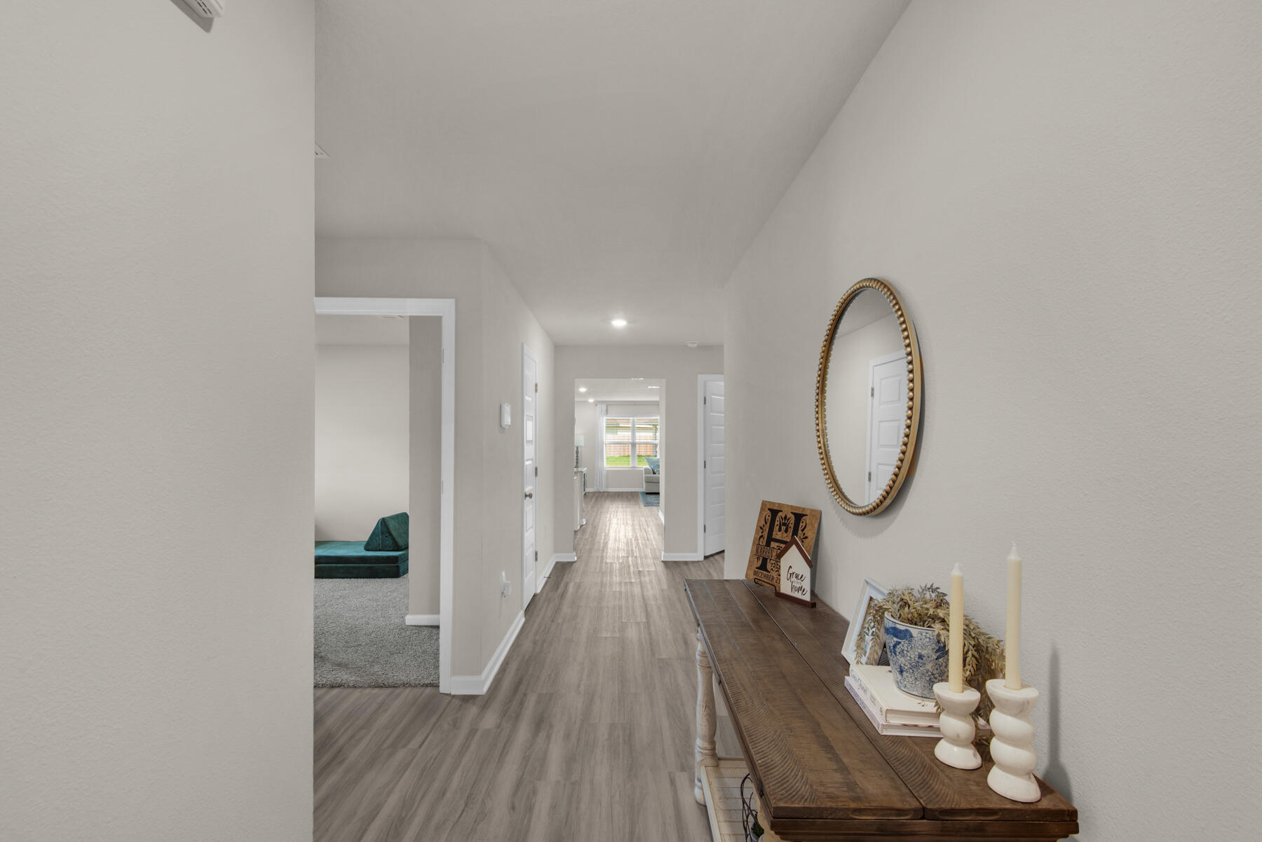 924 Sandbar Loop Crestview, FL 32539 - Photo 21 of 25 a view of a hallway with wooden floor and glass windows