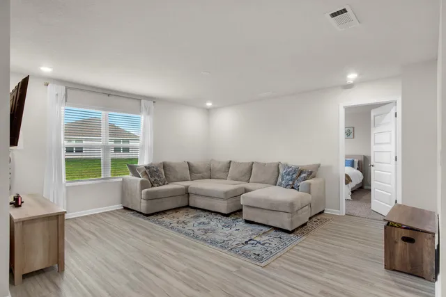 a living room with furniture and a large window