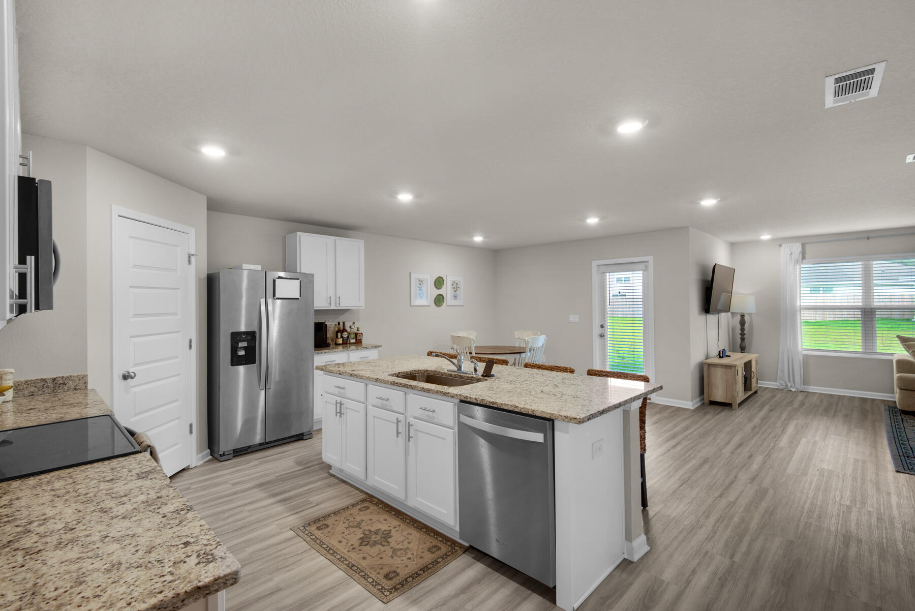 924 Sandbar Loop Crestview, FL 32539 - Photo 9 of 25 a kitchen with stainless steel appliances granite countertop a sink stove and refrigerator