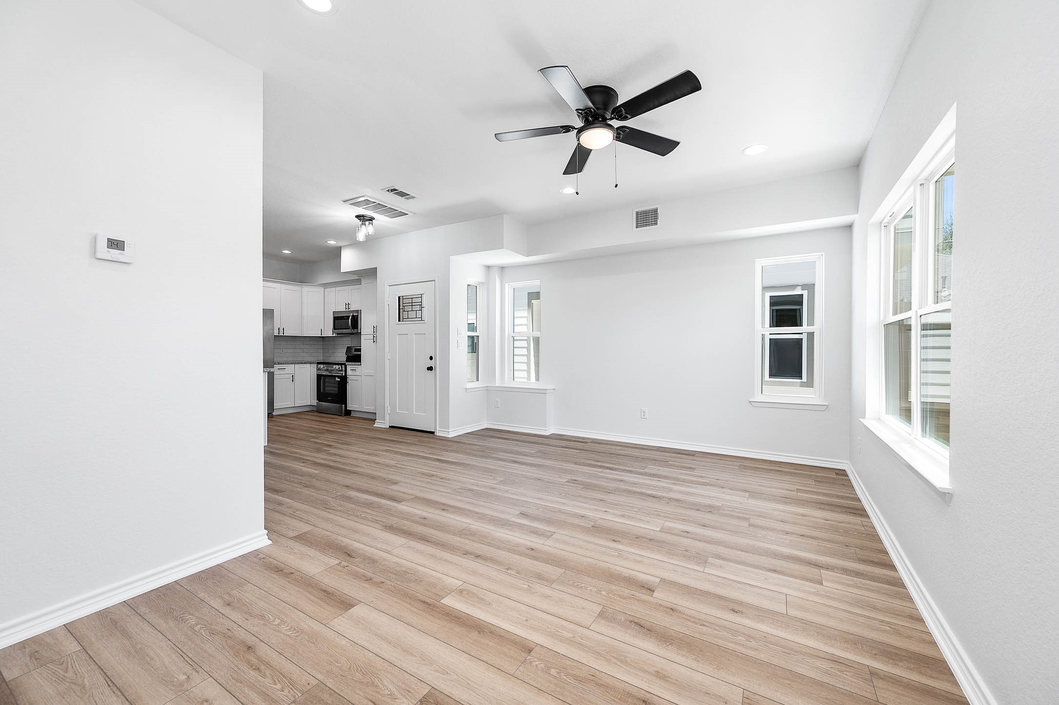 2022 Hampton Street, Unit A B Houston, TX 77088 - Photo 4 of 31 a view of a livingroom with a hardwood floor and a ceiling fan