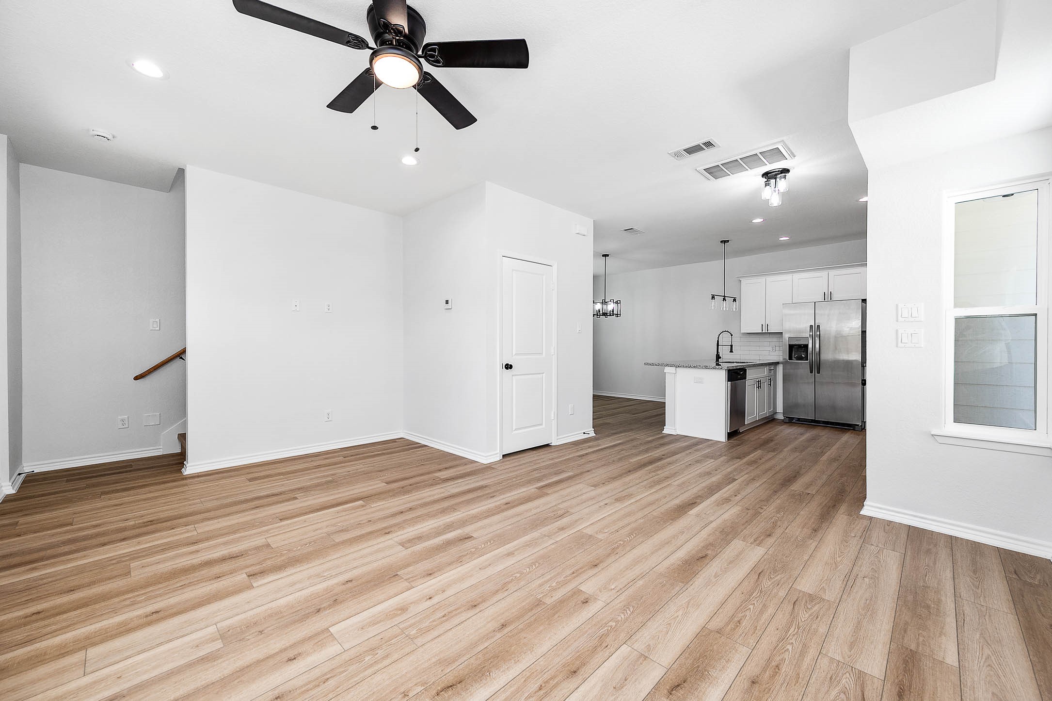 2022 Hampton Street, Unit A B Houston, TX 77088 - Photo 5 of 31 a view of empty room with wooden floor and windows