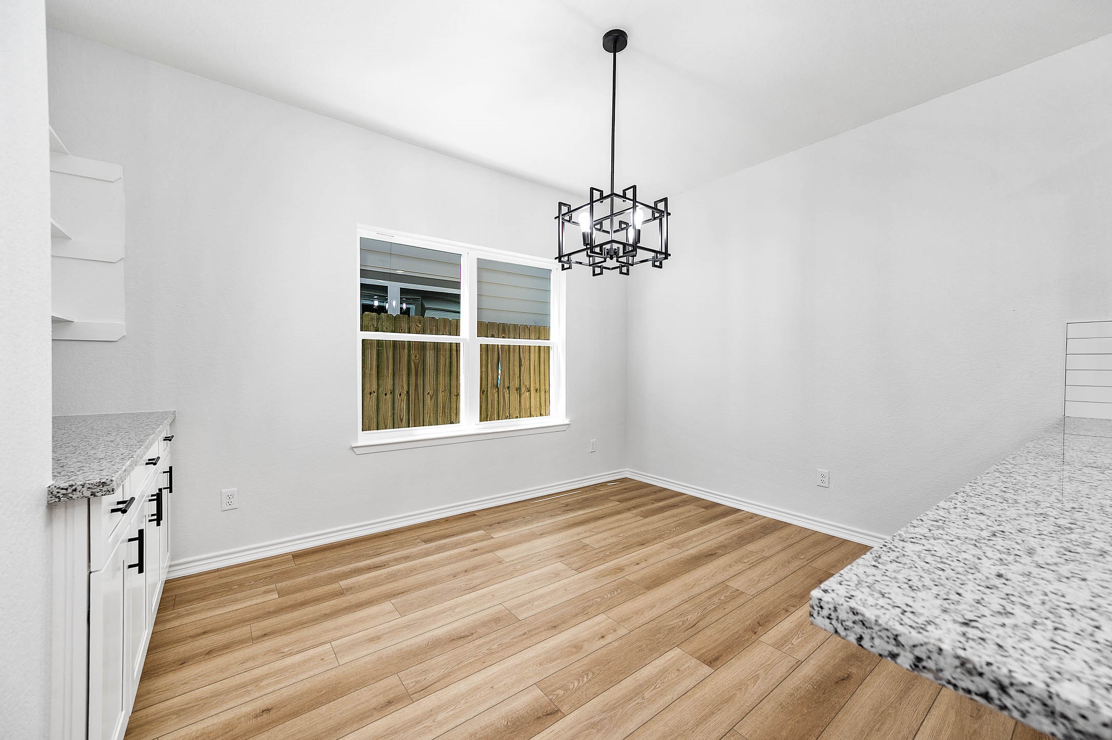 2022 Hampton Street, Unit A B Houston, TX 77088 - Photo 7 of 31 a view of empty room with window and wooden floor