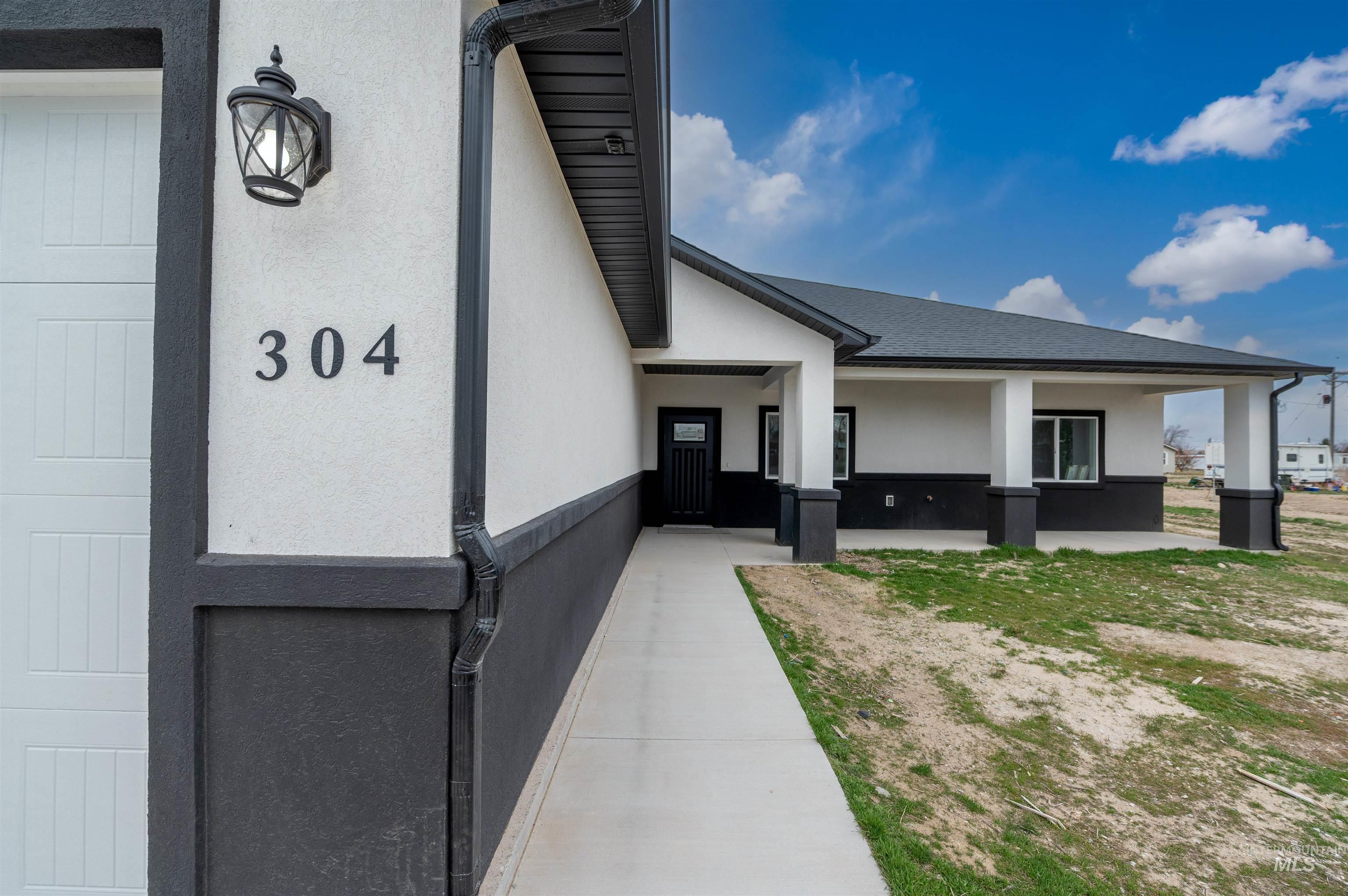 304 Shillington Court Rupert, ID 83350 - Photo 5 of 40 View of exterior entry featuring stucco siding and covered porch