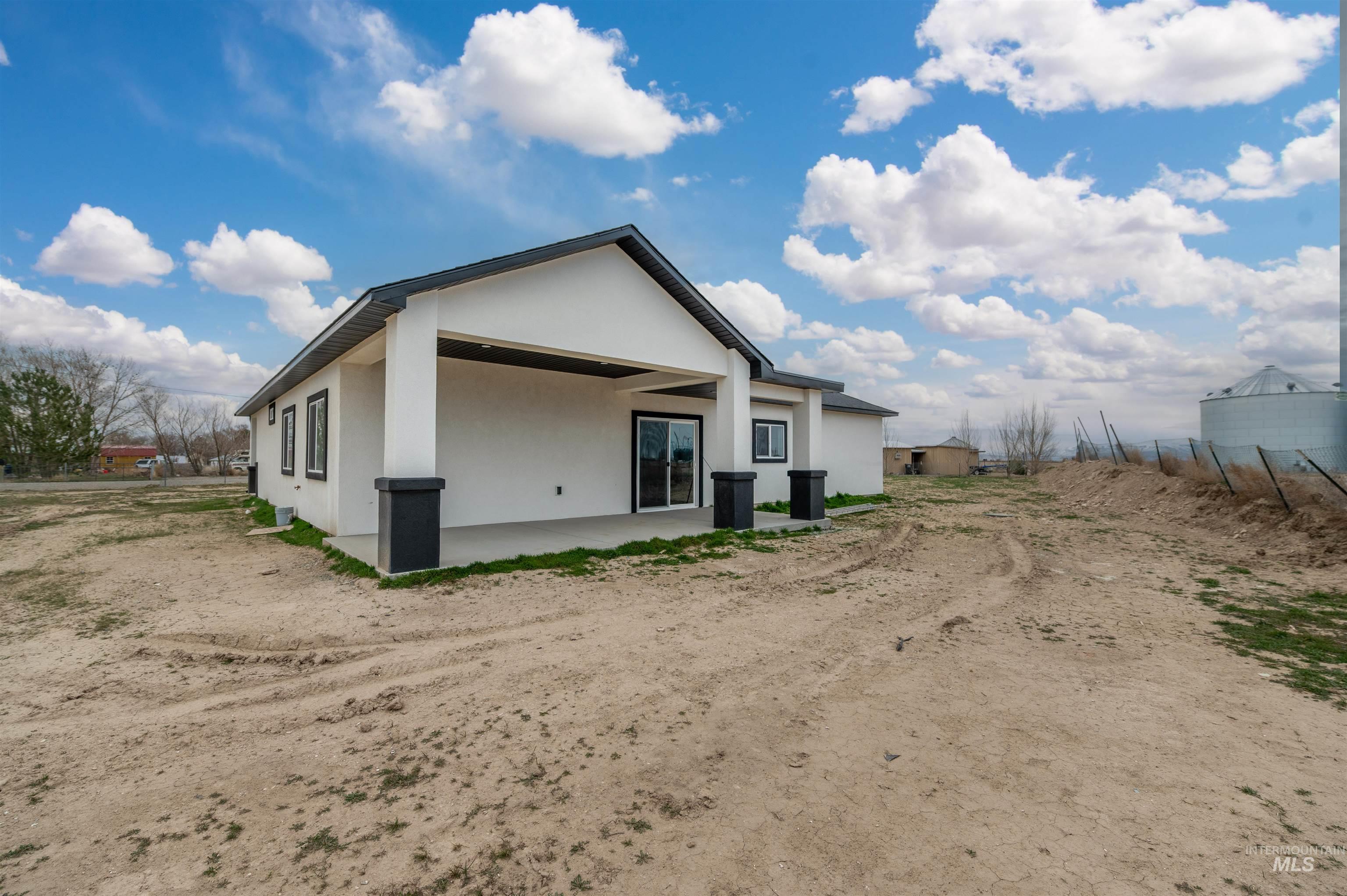 304 Shillington Court Rupert, ID 83350 - Photo 7 of 40 Rear view of property featuring stucco siding and a patio area