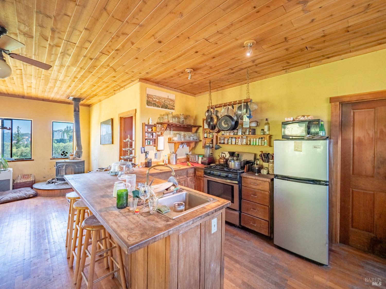 19780 Yorkville Ranch Road Yorkville, CA 95494 - Photo 25 of 49 a kitchen with stainless steel appliances granite countertop a refrigerator a stove and a wooden floors
