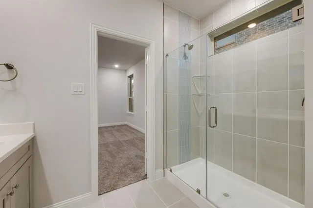 a bathroom with a glass shower door