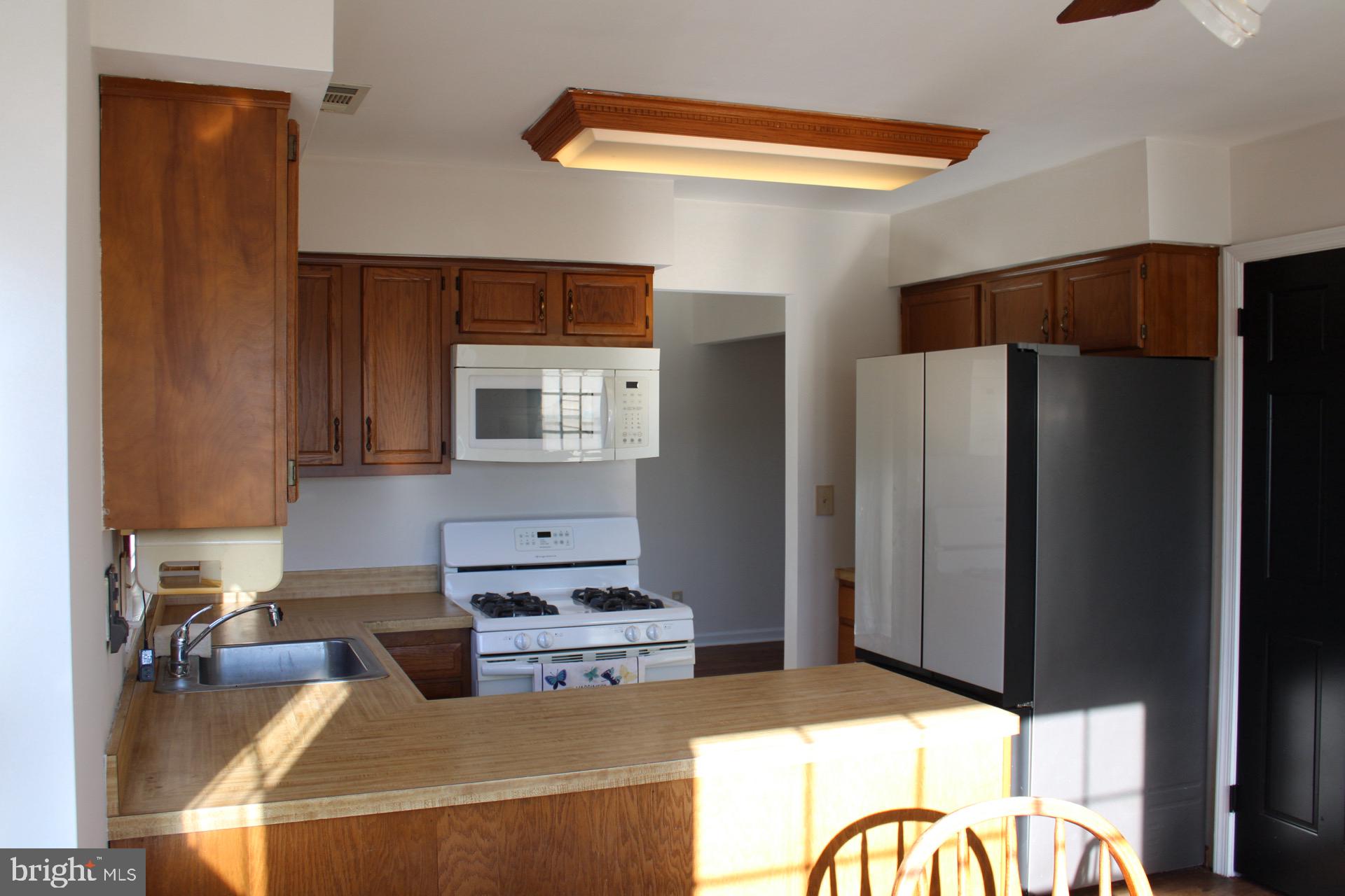 13 Langley Drive Sewell, NJ 08080 - Photo 12 of 31 a kitchen with stainless steel appliances granite countertop a refrigerator and a stove top oven