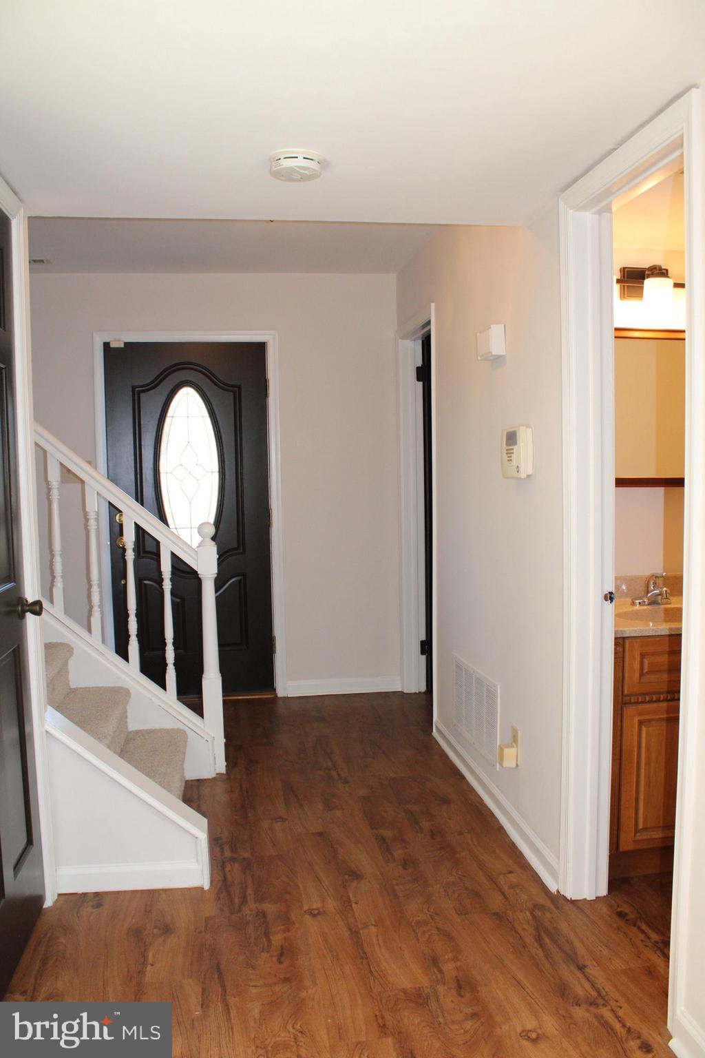 13 Langley Drive Sewell, NJ 08080 - Photo 13 of 31 a view of a hallway with wooden floor and a living room