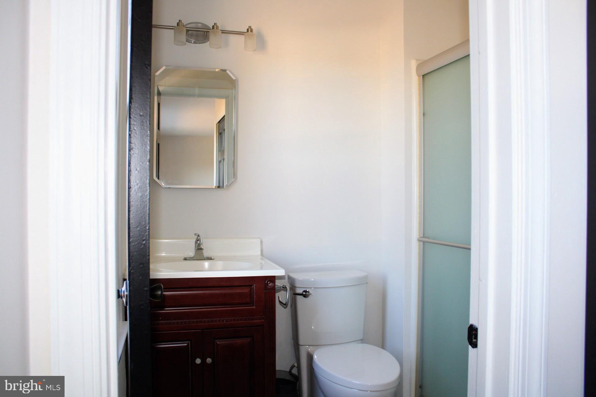 13 Langley Drive Sewell, NJ 08080 - Photo 22 of 31 a bathroom with a toilet sink vanity and mirror