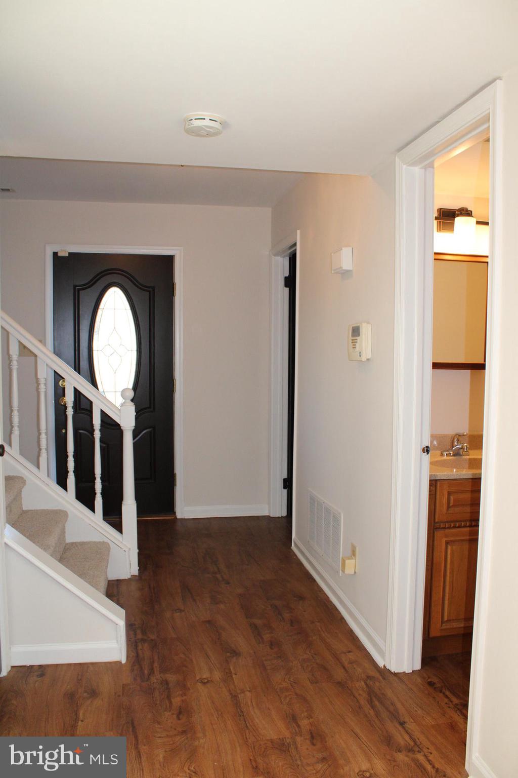 13 Langley Drive Sewell, NJ 08080 - Photo 28 of 31 a view of a hallway with wooden floor and a living room