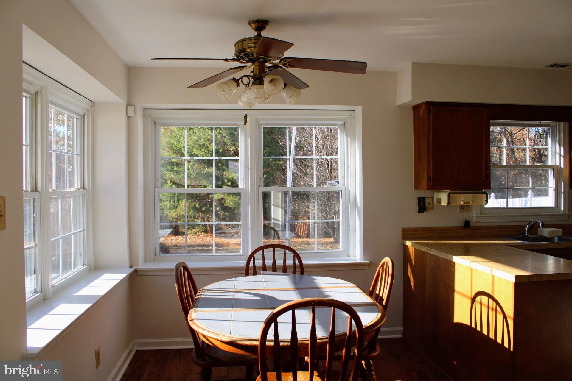 13 Langley Drive Sewell, NJ 08080 - Photo 10 of 31 a dining room with furniture a chandelier and wooden floor