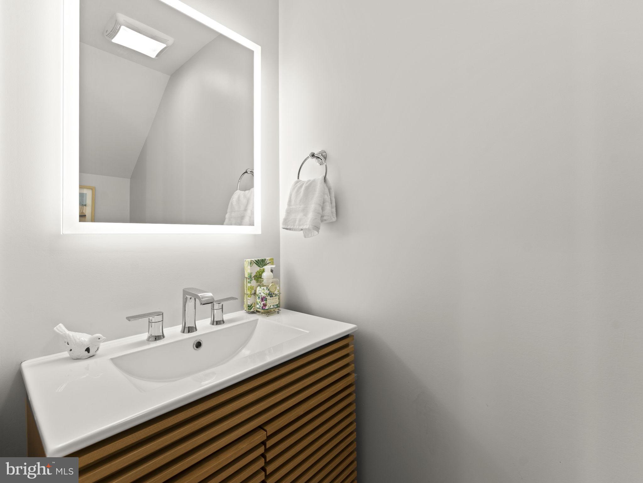 532 Shepherd Street Northwest Washington, DC 20011 - Photo 5 of 28 Powder Room with Fluted Wood Vanity & Dimmable LED