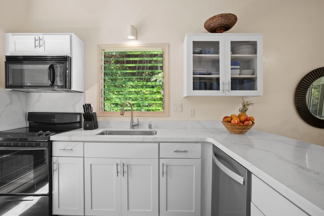 2330 Ho'ohu Road, Unit 27 Koloa, HI 96756 - Photo 11 of 30 a kitchen with a sink and a stove