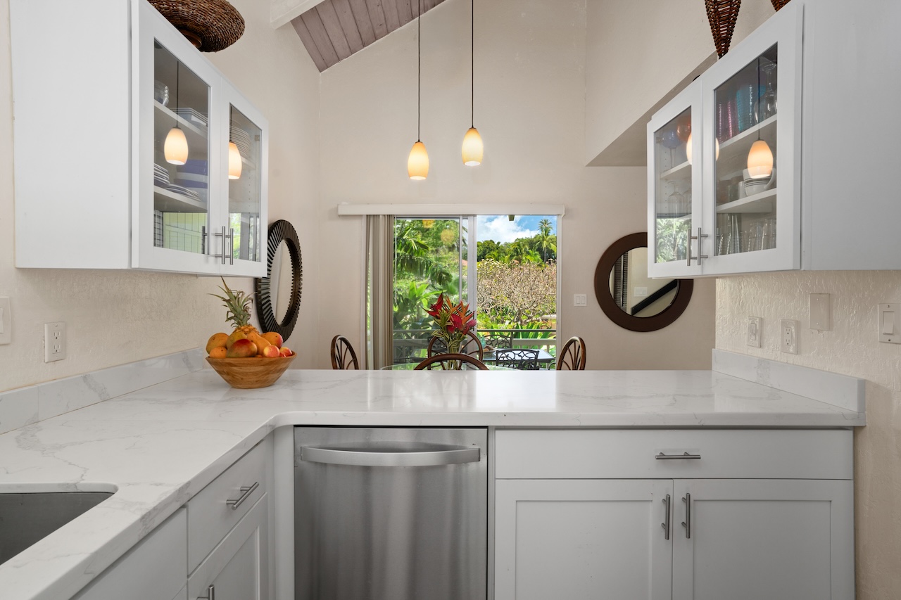 2330 Ho'ohu Road, Unit 27 Koloa, HI 96756 - Photo 12 of 30 a kitchen with a sink and a stove with wooden floor