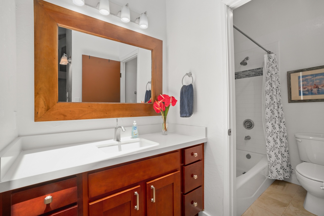 2330 Ho'ohu Road, Unit 27 Koloa, HI 96756 - Photo 17 of 30 a bathroom with a sink and a mirror
