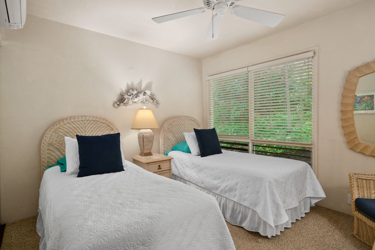 2330 Ho'ohu Road, Unit 27 Koloa, HI 96756 - Photo 18 of 30 a bedroom with a bed lamp and a large window