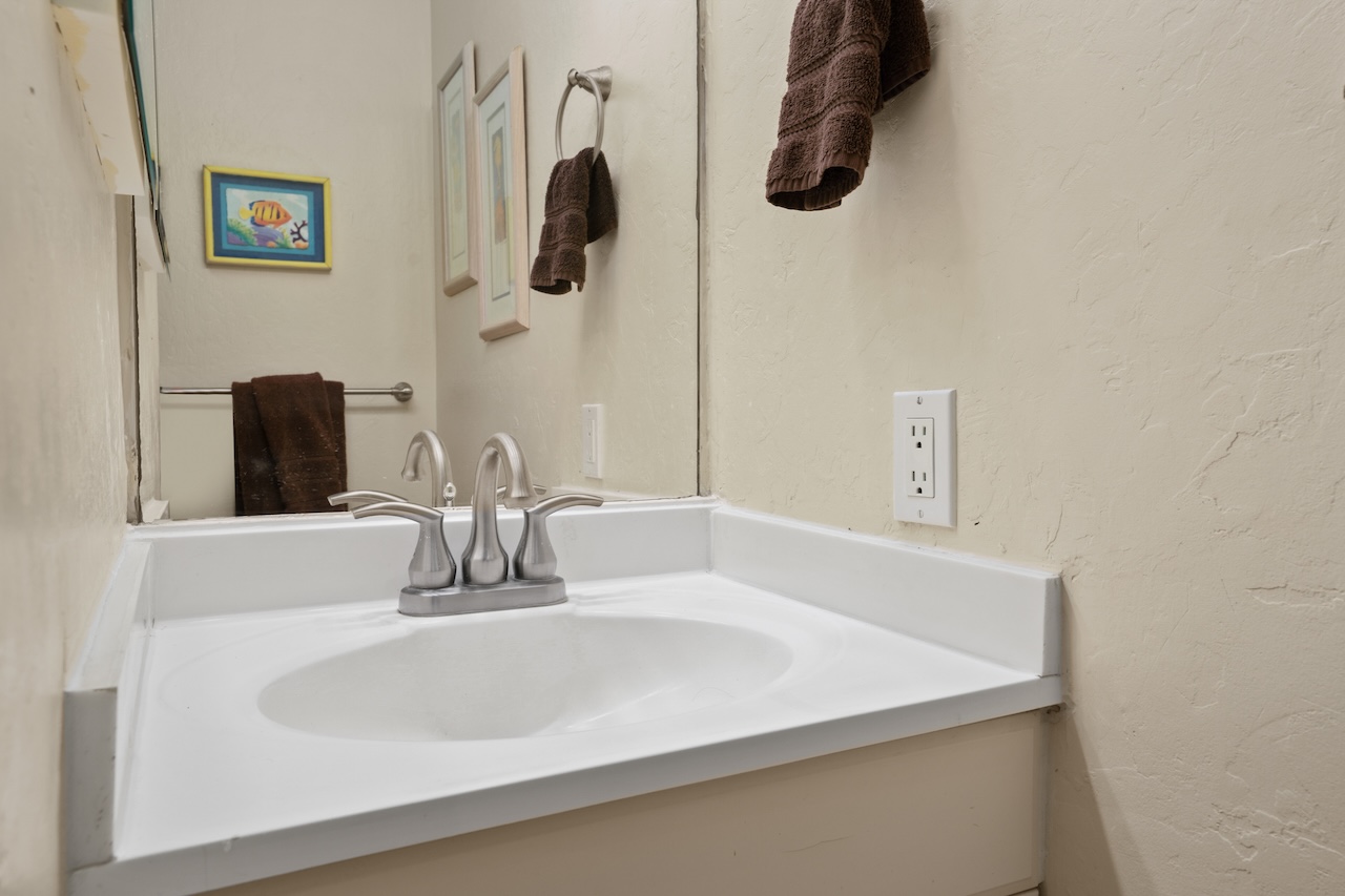 2330 Ho'ohu Road, Unit 27 Koloa, HI 96756 - Photo 21 of 30 a bathroom with a sink and a mirror
